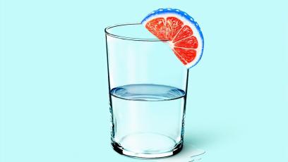 Glass of water with a citrus wedge on the rim