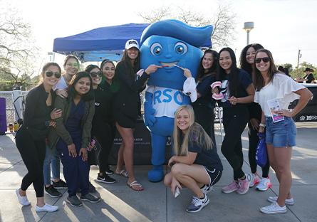 dental hygiene students posing with Splash mascot at the 2022 Dash event