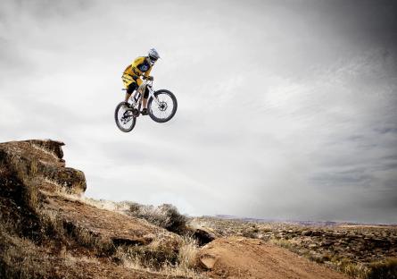 Mountain bike jumping over a desert