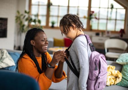 Parent helping her child get ready for school