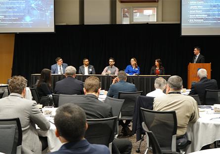 photo of another panel plus the crowd at the event