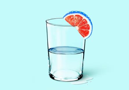 Glass of water with a citrus wedge on the rim