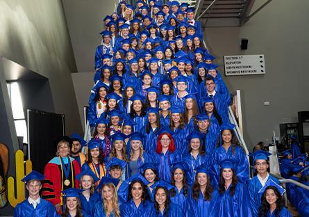 group shot of dual enrollment students lined up descending on a staircase