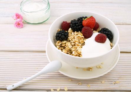 A bowl of yogurt with fruit and granola