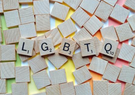 Scrabble tiles that spell out LGBTQ+