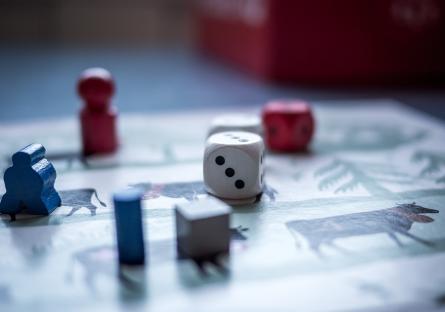 A board game with its dice and pieces laid out