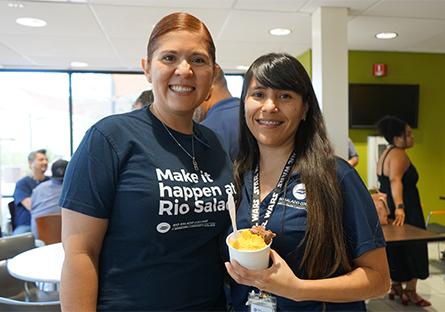 two female employees having ice cream at a social event