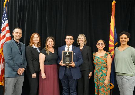 Rio southern staff pose with the plague commemorating 10 years