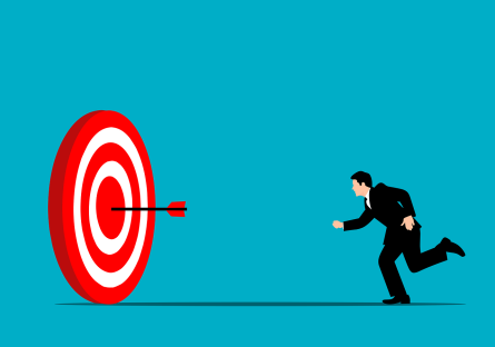 Cartoon image of a man running toward a large target with an arrow in the bullseye position