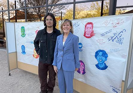 President Kate Smith with mural artist Isaac Baca