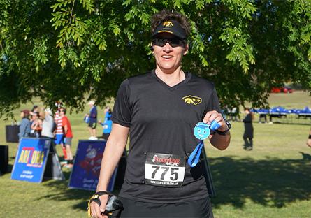 runner holding up medal