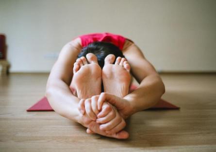 Woman doing a yoga stretch on a mat